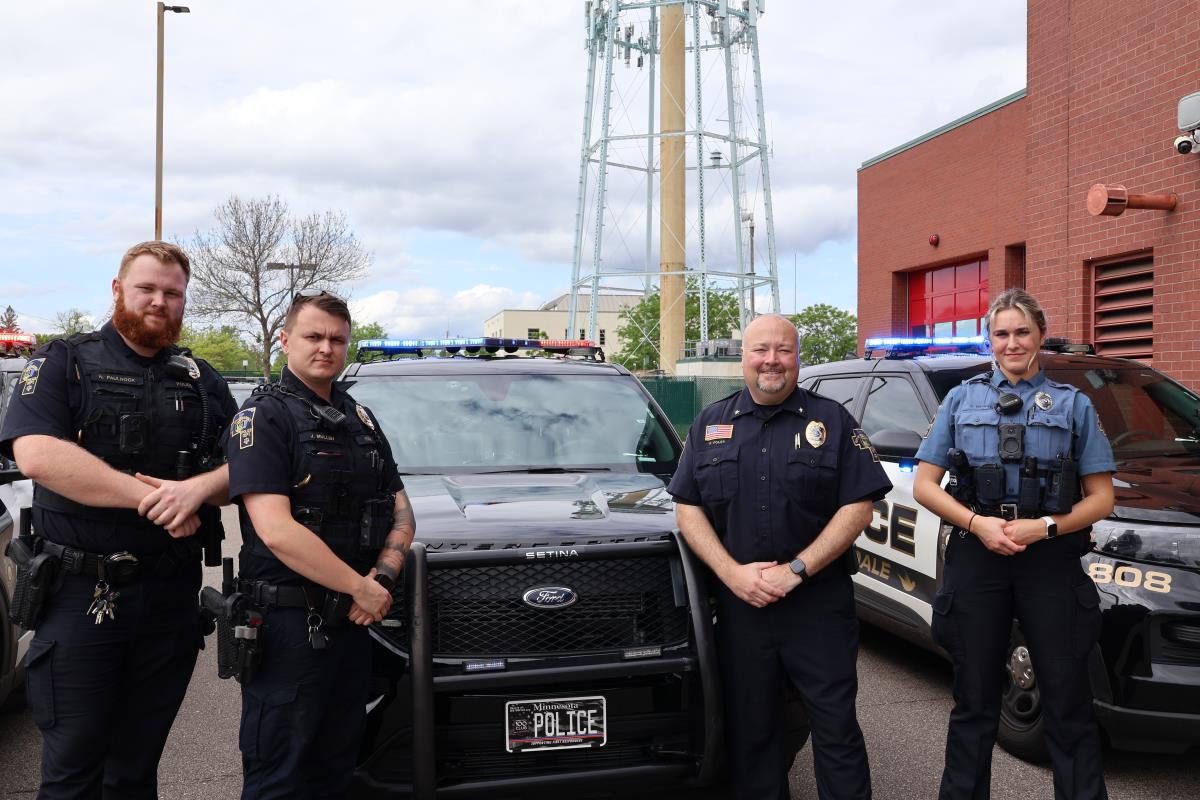 Police Officers standing in front of squad cars