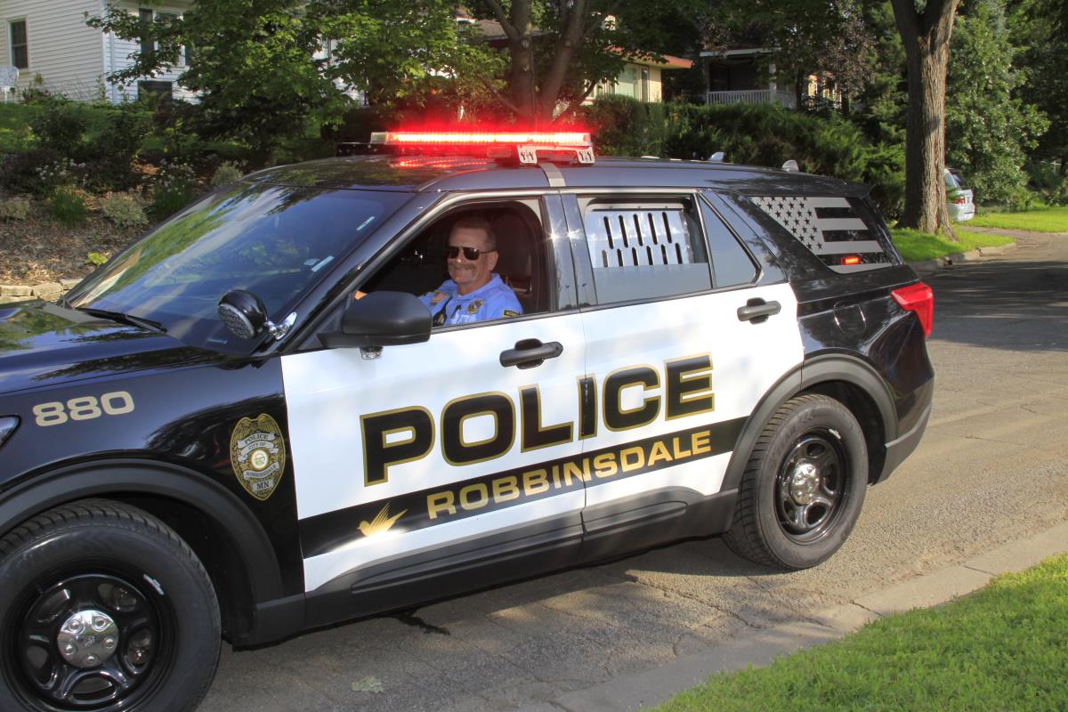 Police Volunteer waving in parade