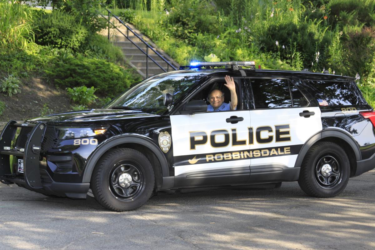 Police Volunteer waving in parade